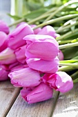 Tulips 'Don Quichotte' on wooden table