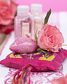 Pink rose on silk cushion, bath products