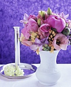 Vase of peonies and silver candlestick