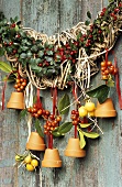 Terracotta pots filled with bird food on rose hip garland