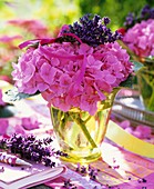 Pink hydrangeas with bunch of lavender in glass vase