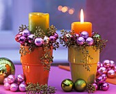 Arrangement of candles, eucalyptus and Christmas baubles