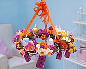Hanging wreath of spring flowers and Easter candles
