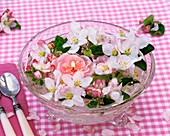 Apple blossom and floating candle in glass bowl