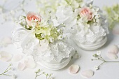 White baby shoes with roses and gypsophila
