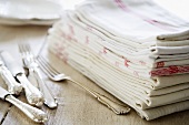 Silvery cutlery and tea towels