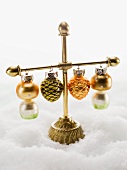 Christmas tree ornaments hanging on stand in snow