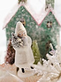 Father Christmas in front of cardboard house (Christmas decoration)