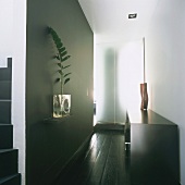 Hallway with glass partition, flower arrangement and sideboard