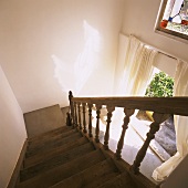 View down wooden staircase with wooden balustrade
