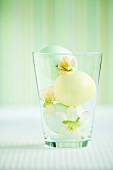 Easter eggs and flowers in glass