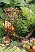 Metal cornucopia filled with apricots, redcurrants & roses