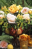 Bowl of fruit decorated with roses on garden table