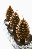 Three pine cone-shaped Christmas candles