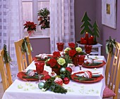 Christmas table decorated with carnations, pine, baubles