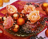 Christmas arrangement of roses, Christmas baubles & dates