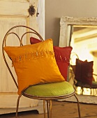Chair with colourful cushions in bedroom