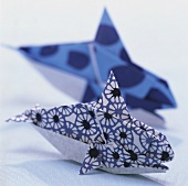 Two folded paper fish (table decoration)