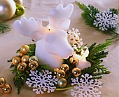 Candle in shape of elk's head with greenery, stars & baubles