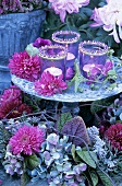 Windlights, chrysanthemums and dahlias on tiered stand