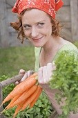 Young woman with carrots