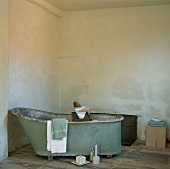 Freistehende Badewanne im Vintage-Stil mit Handtücher und Seifenblock