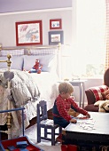 Little boy playing in bedroom