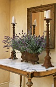 Lavender and candlesticks on table