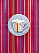 Striped cup on striped tablecloth