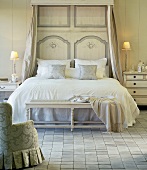 Ein französisches Bett im barockem Stil mit Sitzbank am Bettende