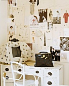 Antiker Schreibtisch und schwarze Damentasche im Arbeitsraum einer Modedesignerin