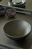 Wooden bowl on dark surface