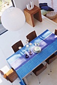 View down onto dining table with blue tablecloth