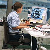 Woman sitting at computer in office