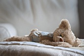 Teddy bear lying on bed