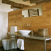 Ein moderner Waschtisch mit Marmorplatte an einer Holztrennwand im rustikalen Bauernhaus