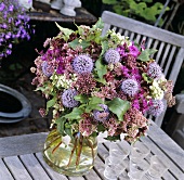 Vase of globe thistles and other flowers
