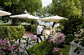 Tables being set up for a wedding reception on a hotel terrace in Italy