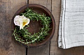 A rosemary wreath with a pansy
