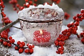 Ice bowl with candle and holly berries