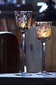 Two windlights (tealights in glasses, Christmas decoration)
