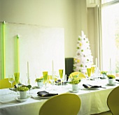 Festive table and artificial Christmas tree