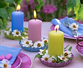 Candles with zinnias in small quiche dishes