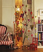 Branch decorated with felt hearts in a living room