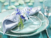Spring place-setting (turquoise tableware, spring flowers)