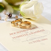 Wedding menu, wedding rings and white rose