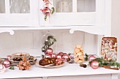 Christmas decorations and biscuits on kitchen cabinet