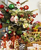 Gifts under small, brightly decorated Christmas tree