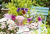 Table decoration of anemones and delphiniums in a teapot
