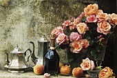 Silver coffee pot and teapot, champagne and vases of roses